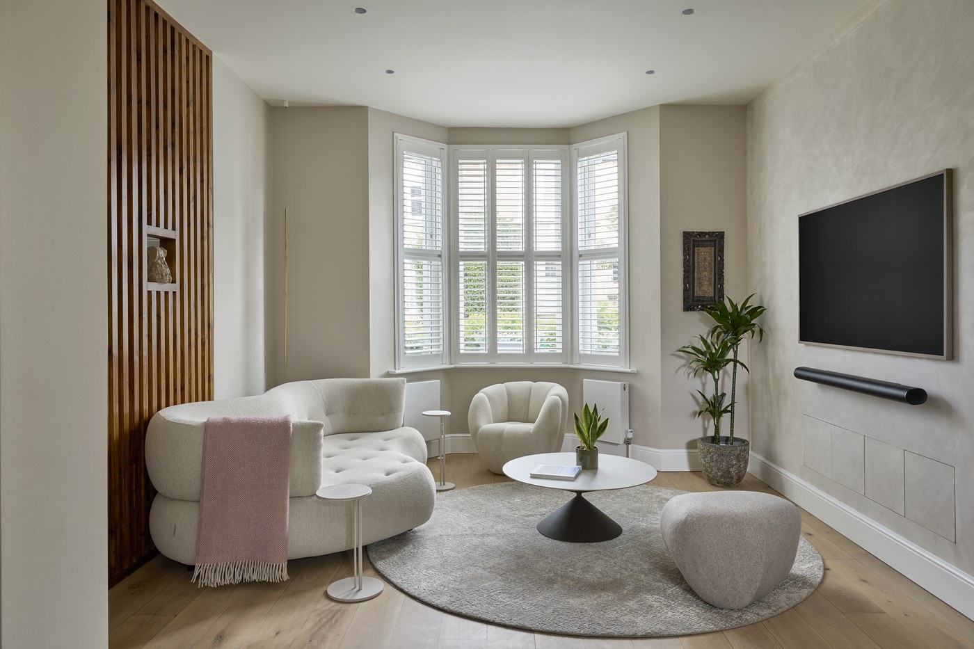 Reception room bay window at Achilles Road with new shutters and joinery