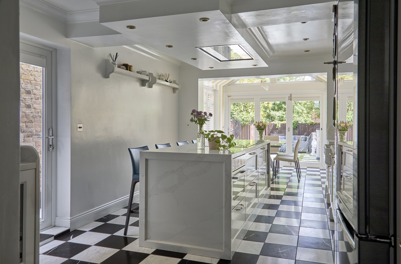 Kitchen extension at Achilles Road with a large rooflight, stone island and chequerboard floor