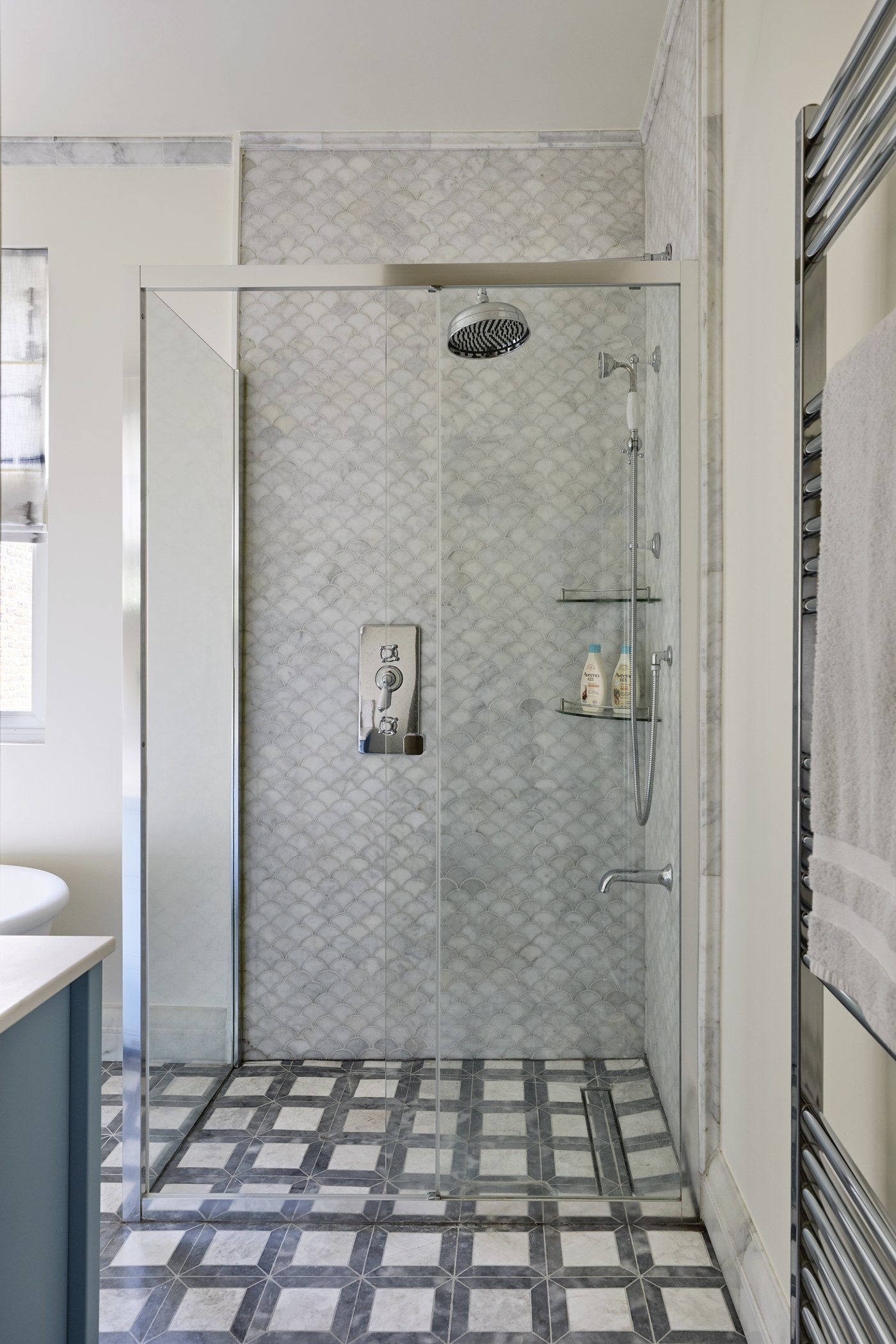 Marble-lined shower room at Achilles Road with mosaic floor