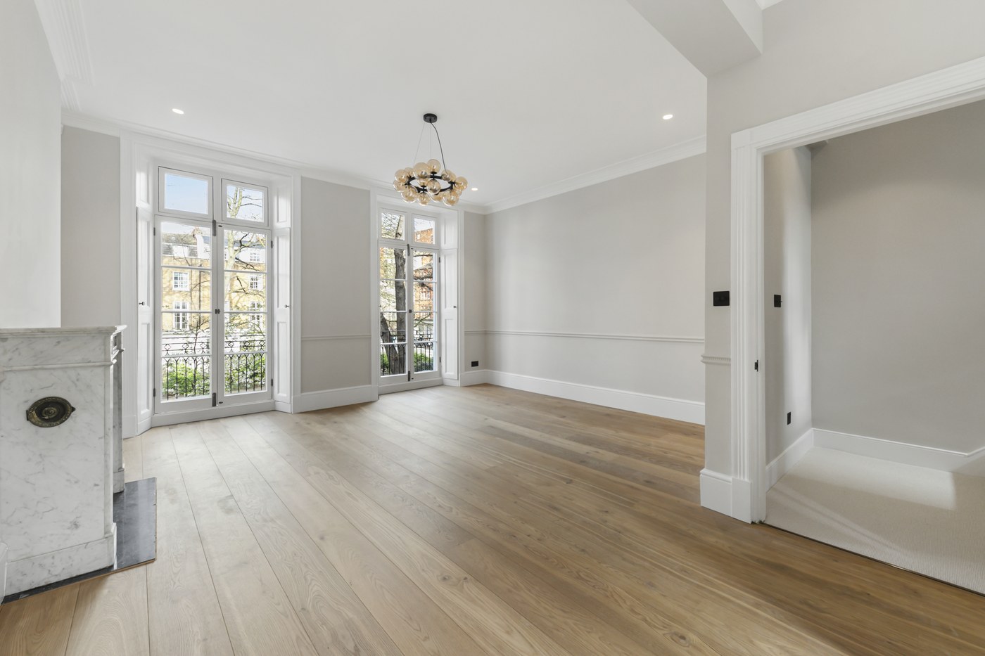 Reception room at Brompton Square with new oak flooring, restored cornice and double doors