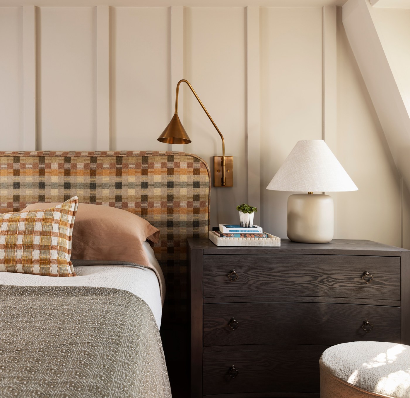 Panelled bedroom wall with brass reading lights at Garratt Lane
