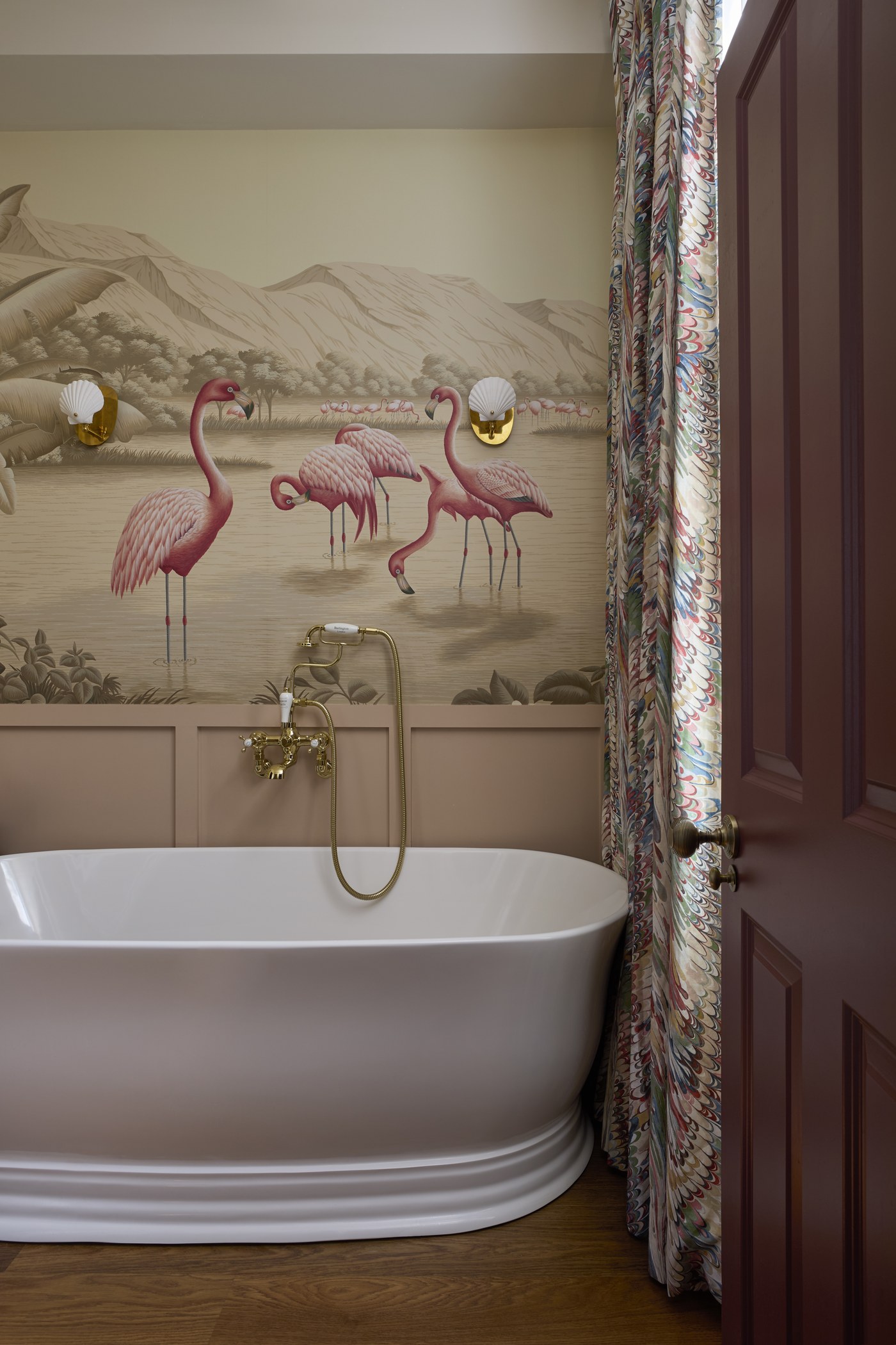 Principal bathroom at Melrose Gardens with a freestanding bath and brass wall-mounted taps