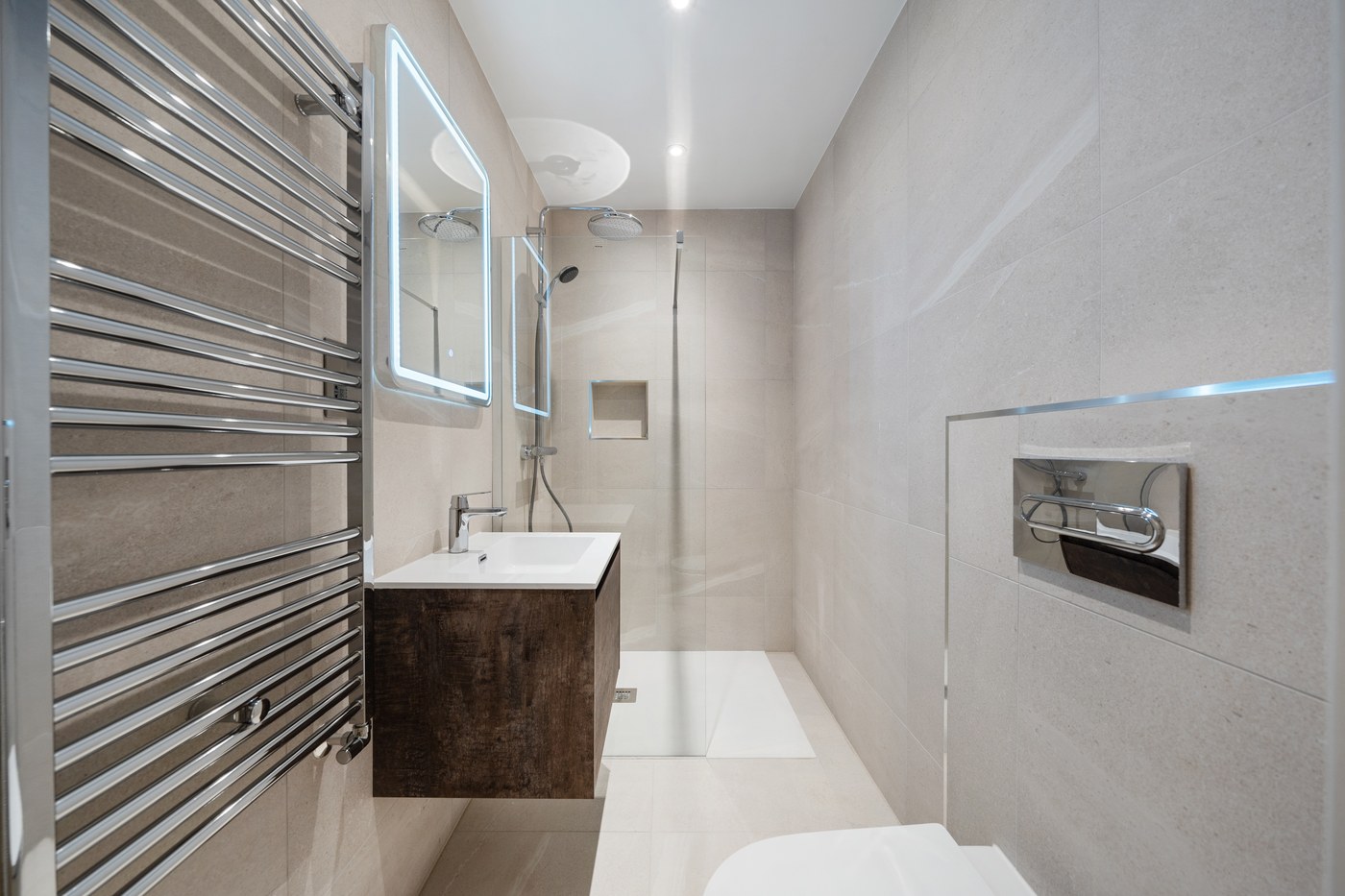 Bathroom at St John's Wood Road with a dark timber vanity against large-format stone