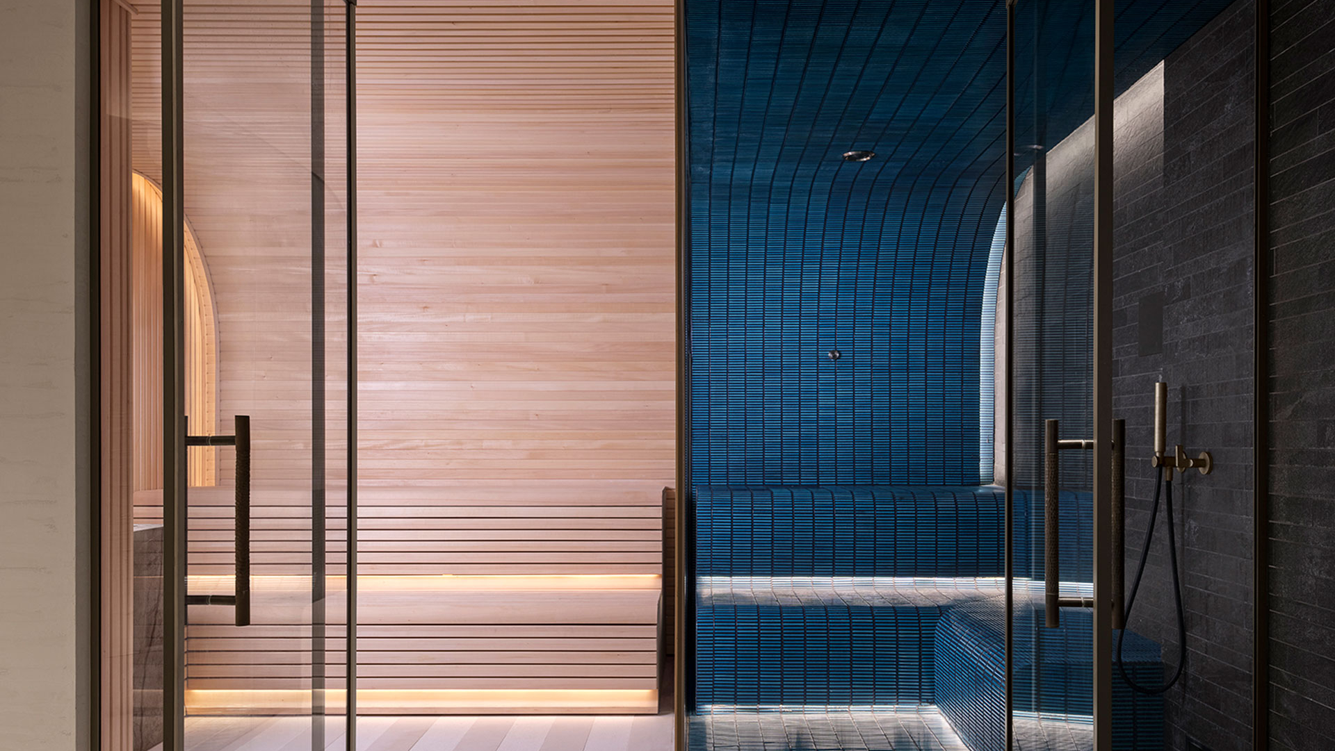 Luxury wellness suite with timber sauna and blue tiled steam room