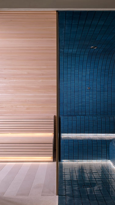 Luxury wellness suite with timber sauna and blue tiled steam room